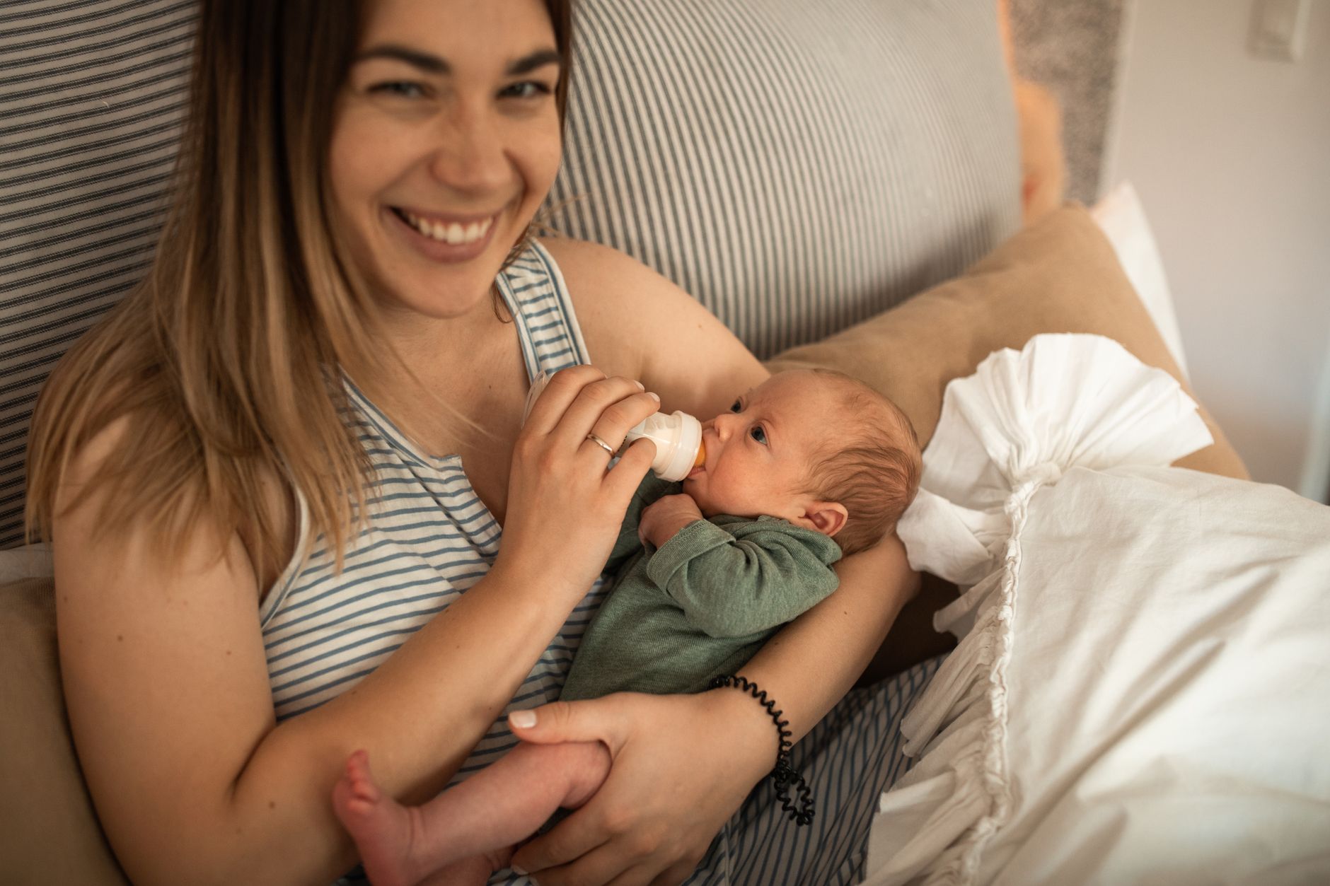 Mother holding her baby at home